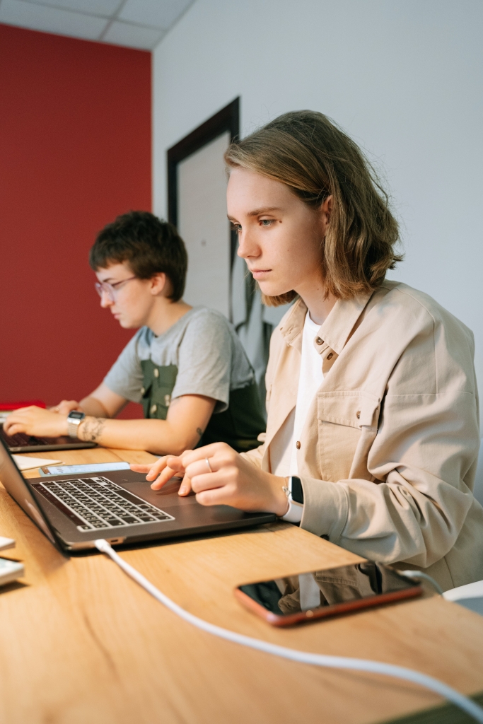Focused students using laptop